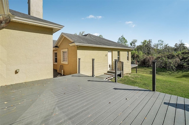 wooden deck featuring a yard