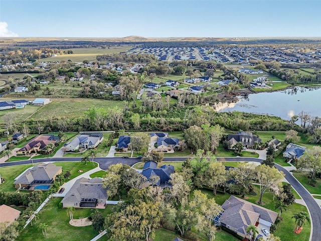 birds eye view of property featuring a water view and a residential view