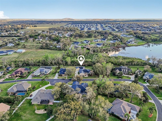 drone / aerial view with a residential view and a water view