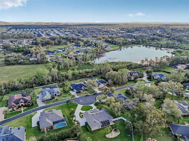 drone / aerial view with a water view and a residential view