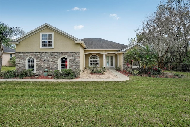 view of front of home with stone siding, a front yard, and stucco siding