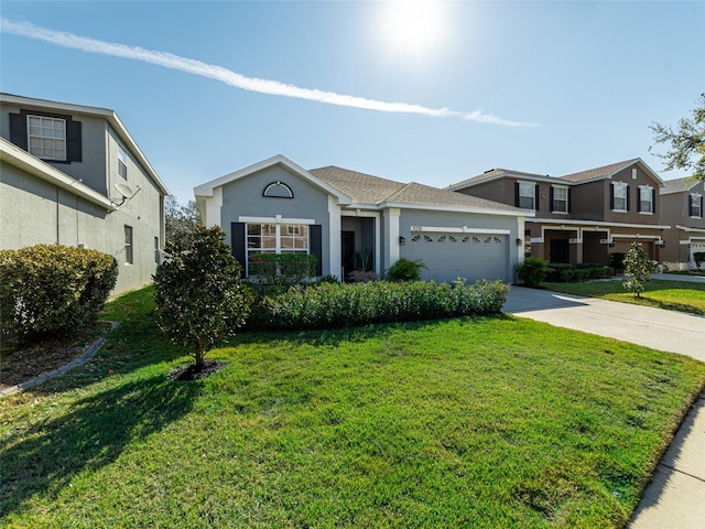 view of front of property with concrete driveway, a front yard, an attached garage, and stucco siding