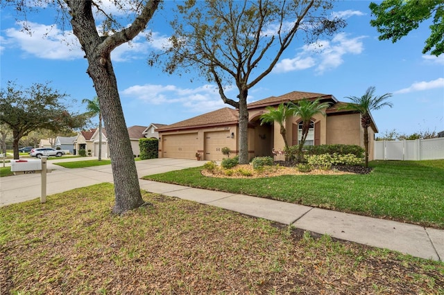 view of front of home featuring a garage, fence, driveway, stucco siding, and a front yard