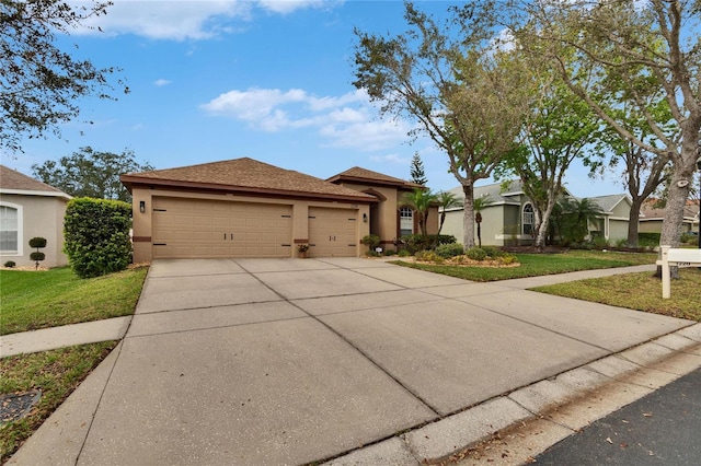 view of front facade with a garage, concrete driveway, a front yard, and stucco siding