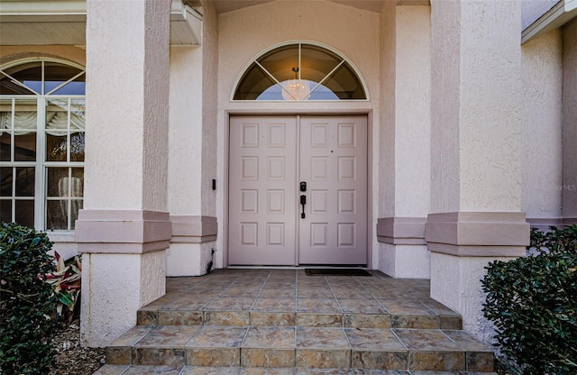 entrance to property with stucco siding