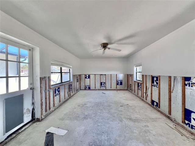 empty room featuring a ceiling fan and a wealth of natural light