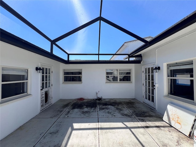 view of patio with glass enclosure