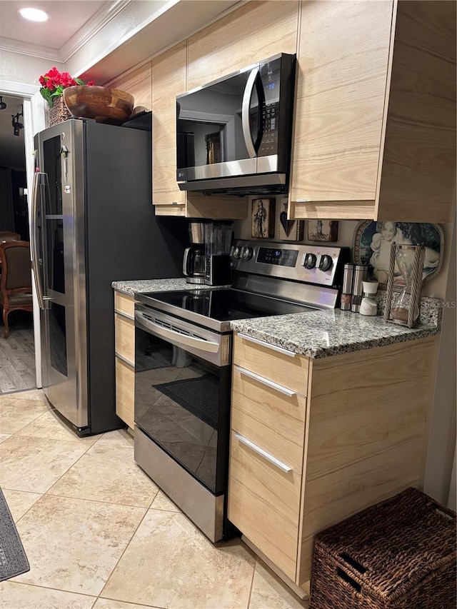 kitchen with crown molding, light tile patterned floors, light brown cabinetry, appliances with stainless steel finishes, and stone countertops