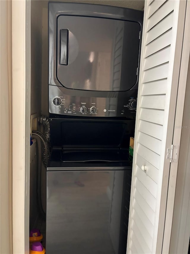 laundry room featuring stacked washer and clothes dryer and laundry area