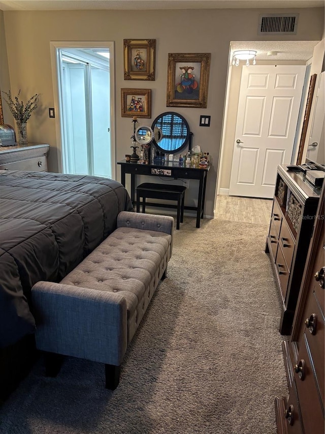 bedroom featuring light carpet and visible vents