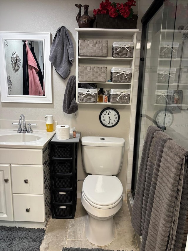 bathroom featuring a stall shower, vanity, and toilet