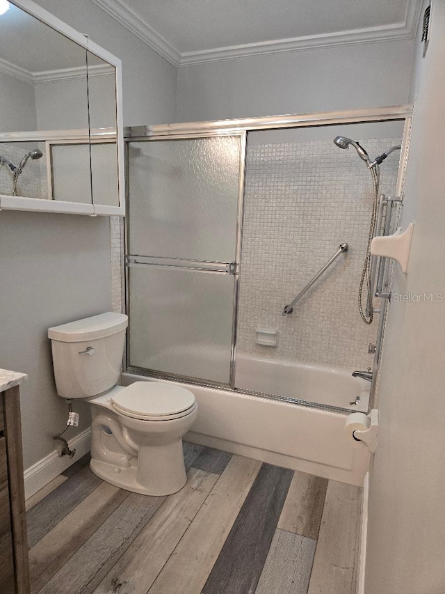 full bath with toilet, ornamental molding, wood finished floors, combined bath / shower with glass door, and vanity