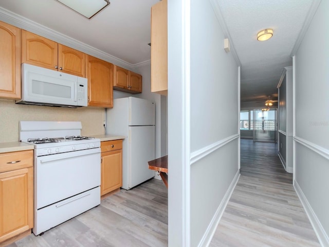 kitchen with white appliances, light wood-style flooring, light countertops, crown molding, and light brown cabinets