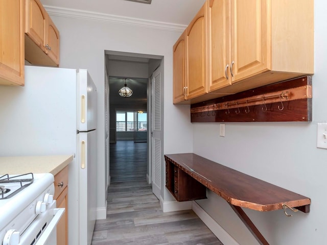 kitchen with light wood-style floors, light brown cabinets, crown molding, and baseboards