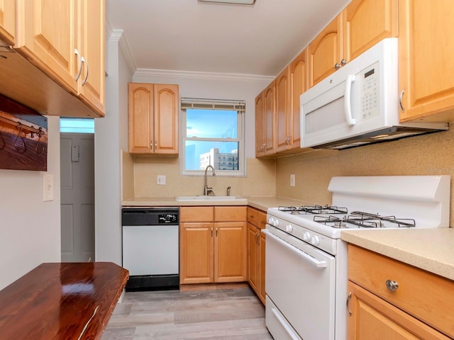 kitchen with light brown cabinets, white appliances, a sink, light countertops, and crown molding