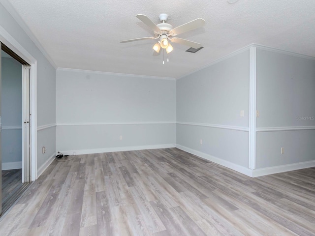 unfurnished room with a ceiling fan, baseboards, light wood-style flooring, and a textured ceiling