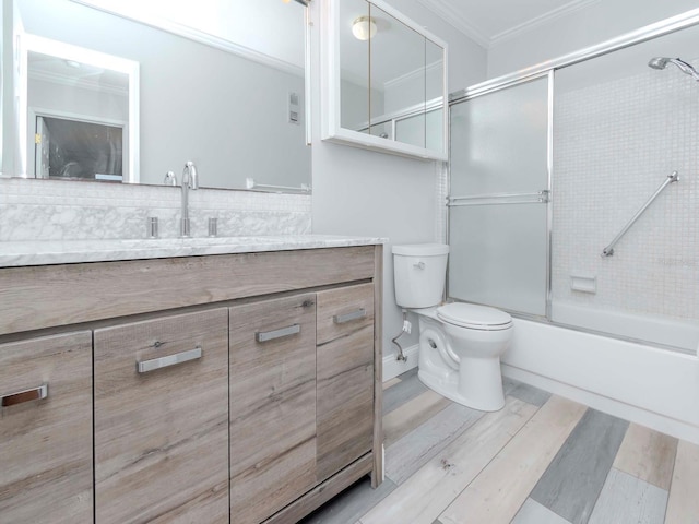 full bathroom featuring crown molding, backsplash, toilet, vanity, and wood finished floors