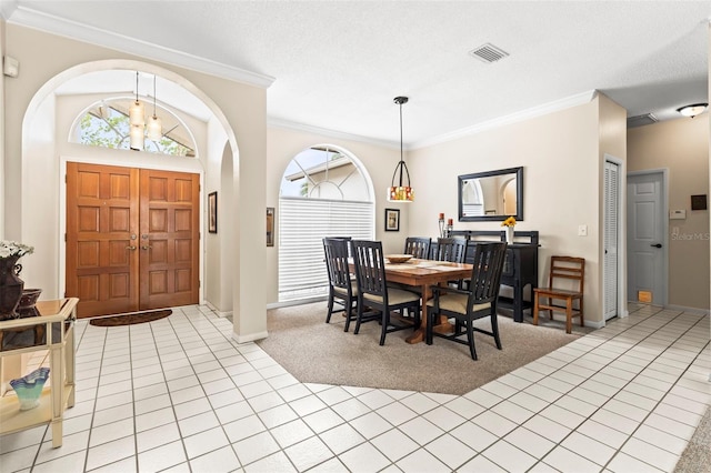 dining area featuring light carpet, visible vents, and plenty of natural light