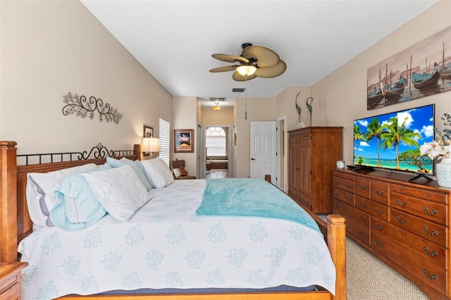 bedroom with light colored carpet, a ceiling fan, and visible vents