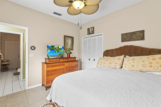 bedroom with visible vents, baseboards, a closet, a ceiling fan, and light tile patterned flooring