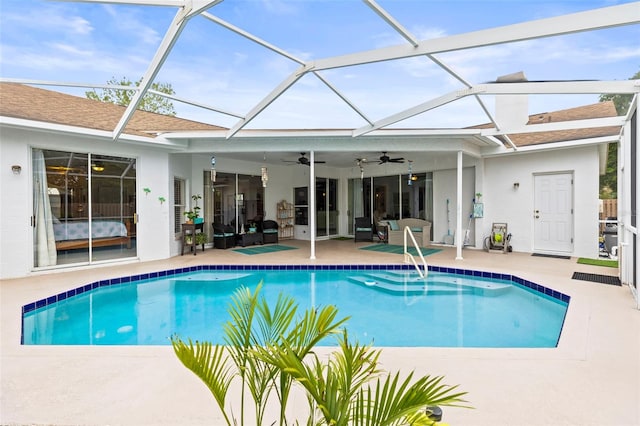 outdoor pool with a patio, a lanai, and a ceiling fan