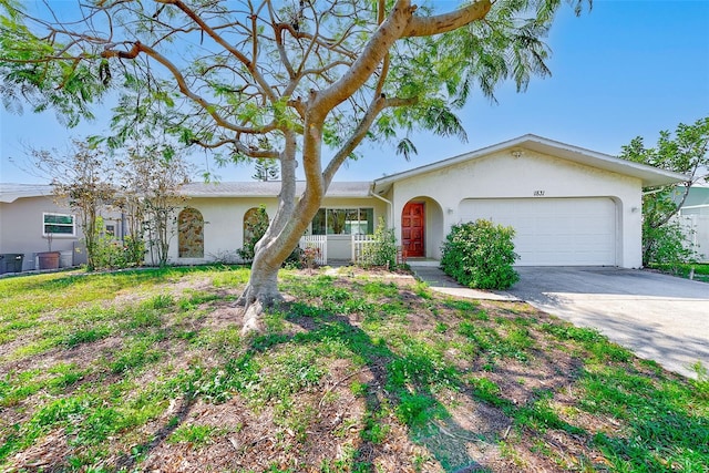 ranch-style house with concrete driveway, an attached garage, and stucco siding