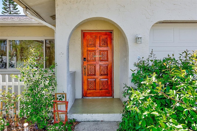 property entrance with stucco siding