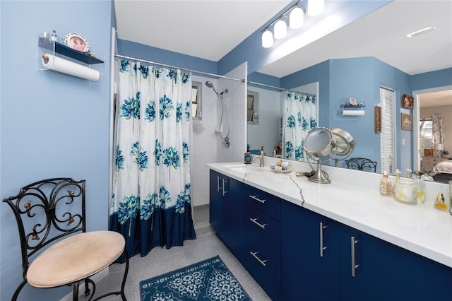 full bathroom with curtained shower and vanity