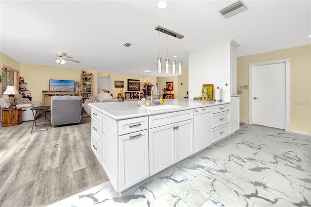 kitchen featuring white dishwasher, a sink, visible vents, a ceiling fan, and marble finish floor