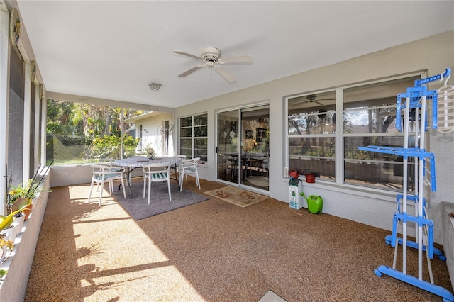 sunroom featuring ceiling fan