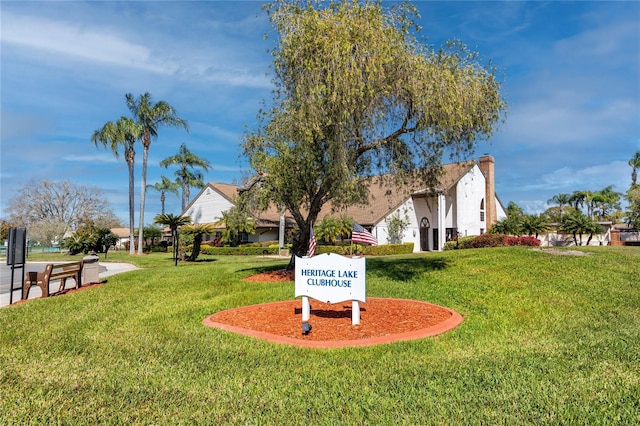 view of home's community with a yard