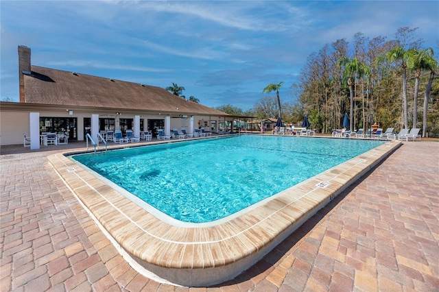 community pool with a patio area