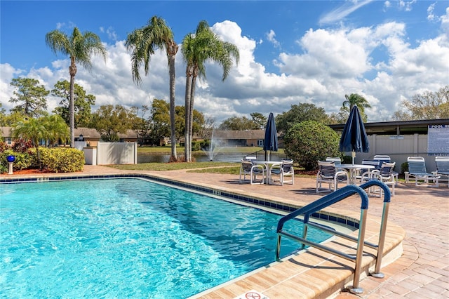 pool featuring fence and a patio