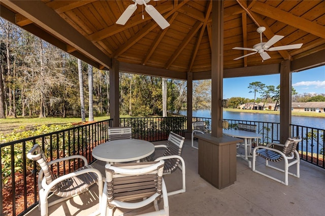 view of patio / terrace with a gazebo, outdoor dining area, a water view, and a ceiling fan