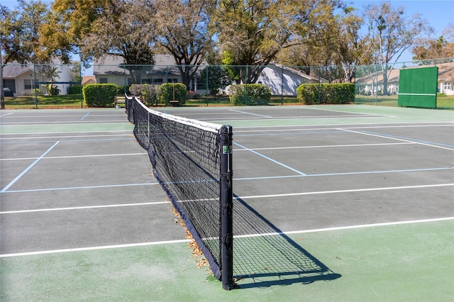 view of tennis court featuring fence