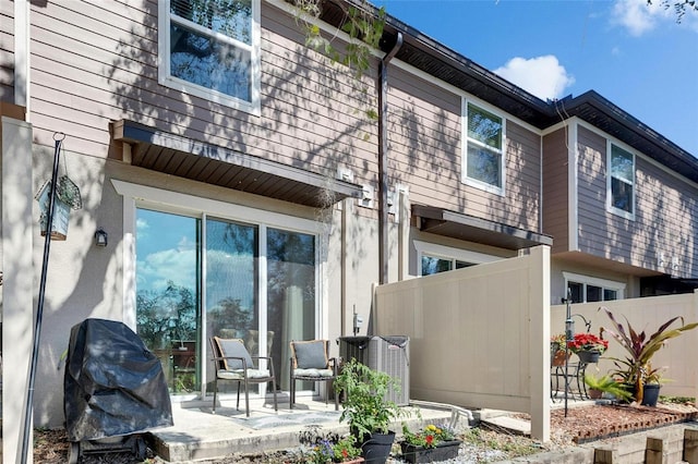 back of property with a patio area and central AC unit