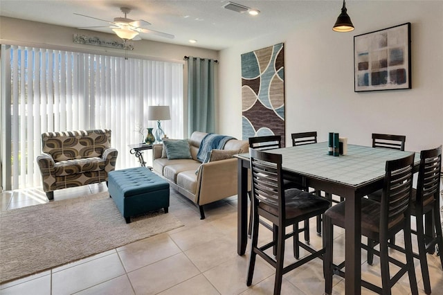 dining space with ceiling fan, light tile patterned flooring, and visible vents