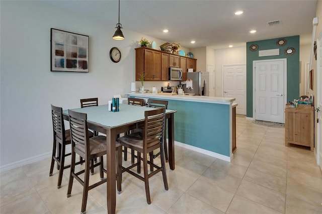 dining space with light tile patterned flooring, baseboards, visible vents, and recessed lighting