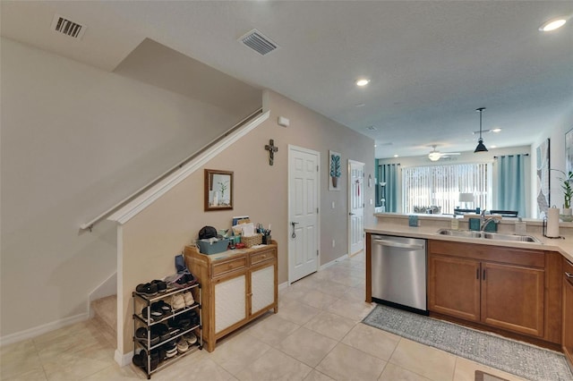 kitchen featuring a sink, visible vents, brown cabinetry, and dishwasher