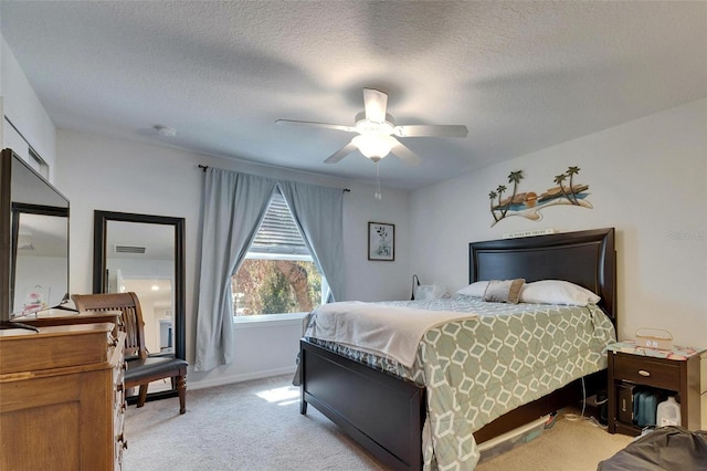 bedroom with a textured ceiling, ceiling fan, baseboards, and light colored carpet