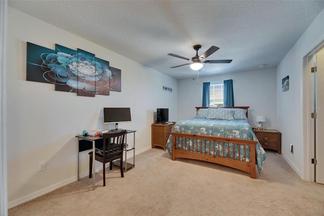 bedroom with a ceiling fan, carpet, baseboards, and a textured ceiling