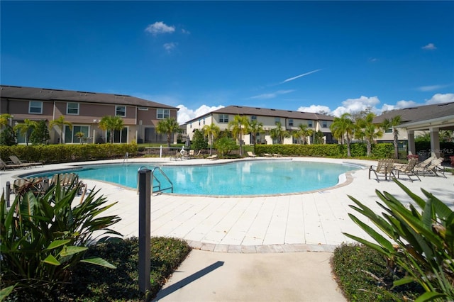 community pool with a residential view and fence