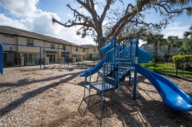 communal playground with fence and a residential view