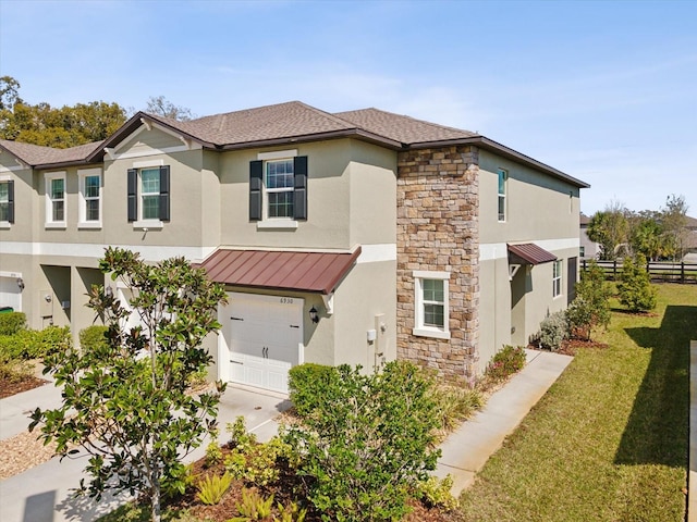 view of front of property featuring stone siding, a standing seam roof, metal roof, and stucco siding