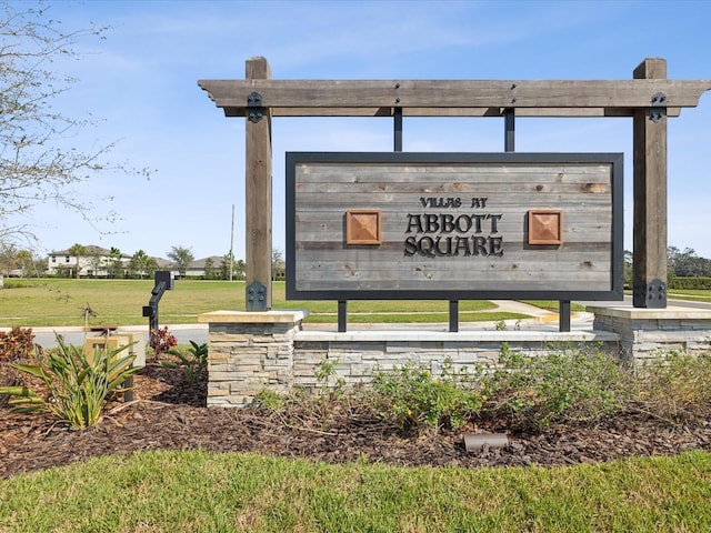 community / neighborhood sign with a yard