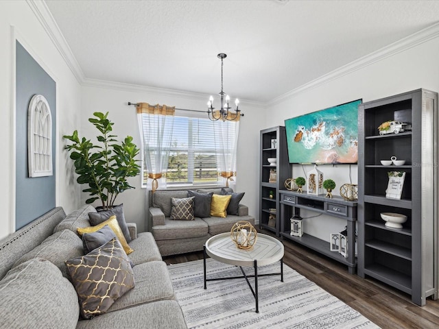 living room with dark wood-style floors, a chandelier, a textured ceiling, and ornamental molding