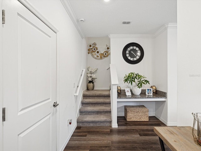 interior space featuring visible vents, baseboards, stairway, dark wood finished floors, and crown molding