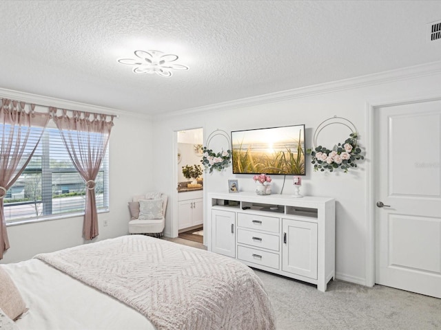 bedroom featuring visible vents, light colored carpet, ensuite bath, ornamental molding, and a textured ceiling