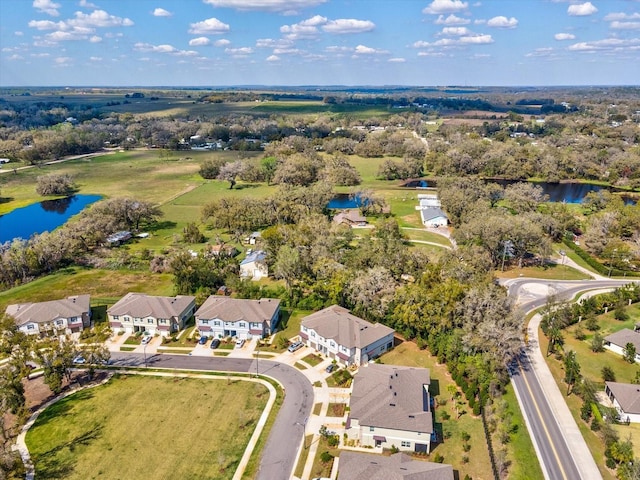 drone / aerial view with a water view and a residential view