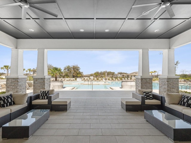 view of patio featuring a community pool, outdoor lounge area, and a ceiling fan